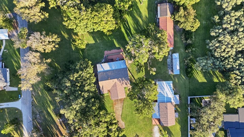 191 Howes Street Oak Hill, FL 32759 - Photo 91 of 98 an aerial view of a house with a yard
