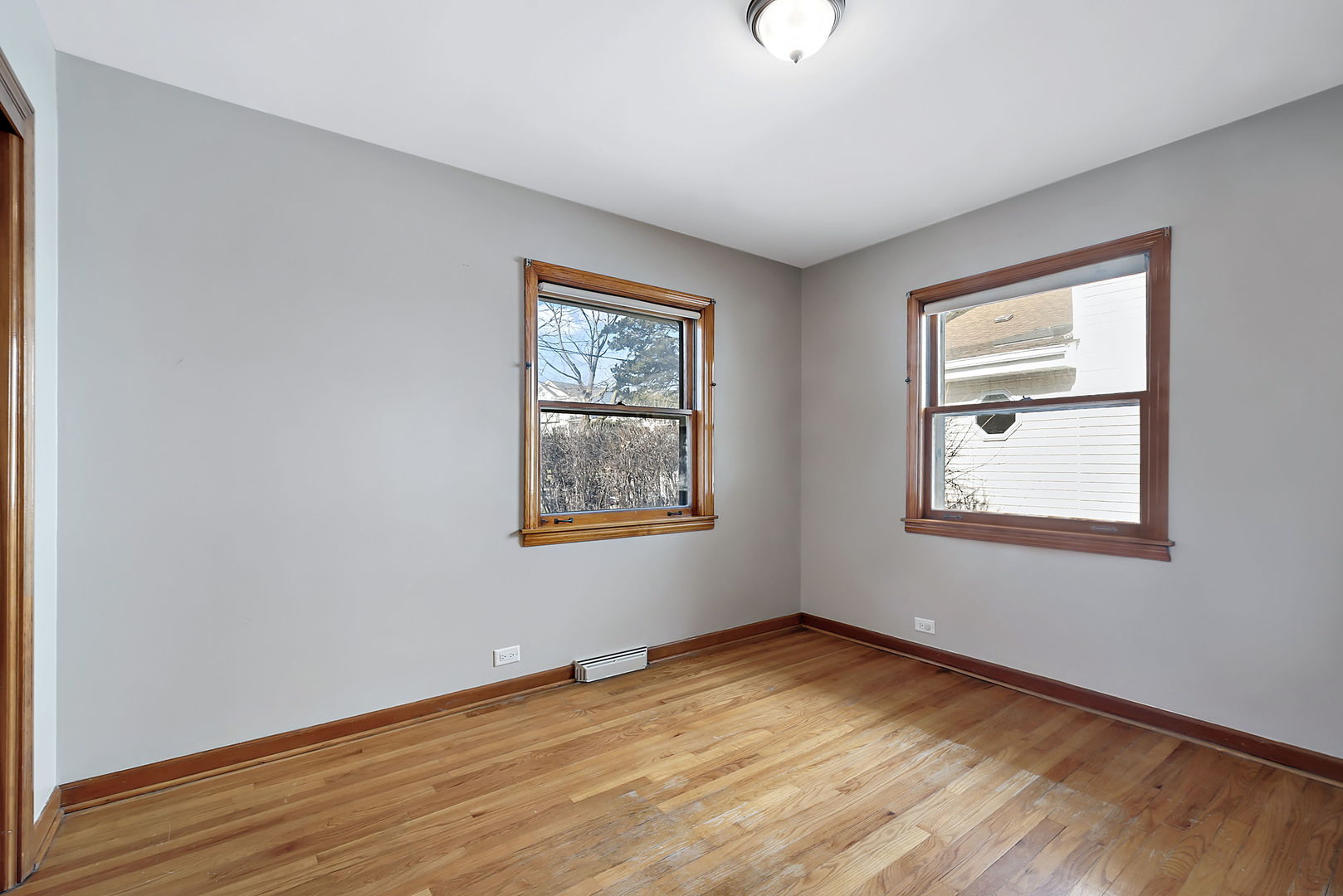 256 North Jackson Road Clarendon Hills, IL 60514 - Photo 15 of 30 a view of an empty room with wooden floor and a window