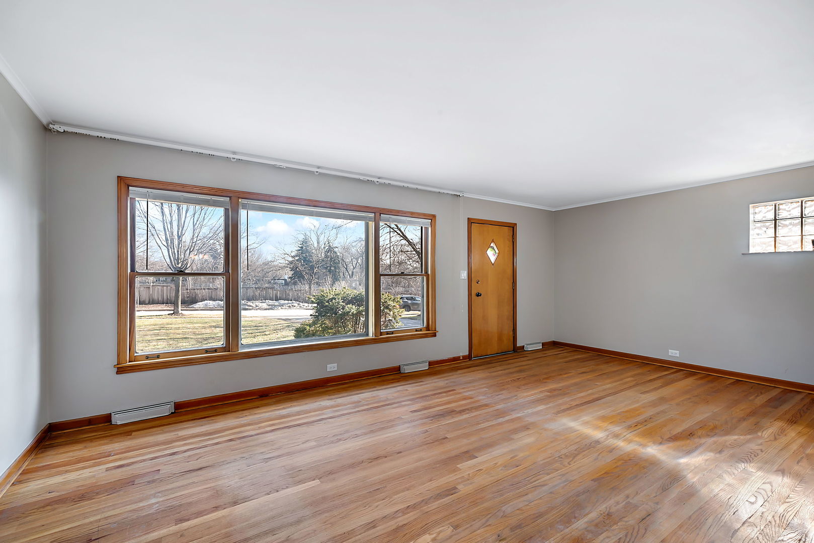 256 North Jackson Road Clarendon Hills, IL 60514 - Photo 3 of 30 an empty room with wooden floor and windows