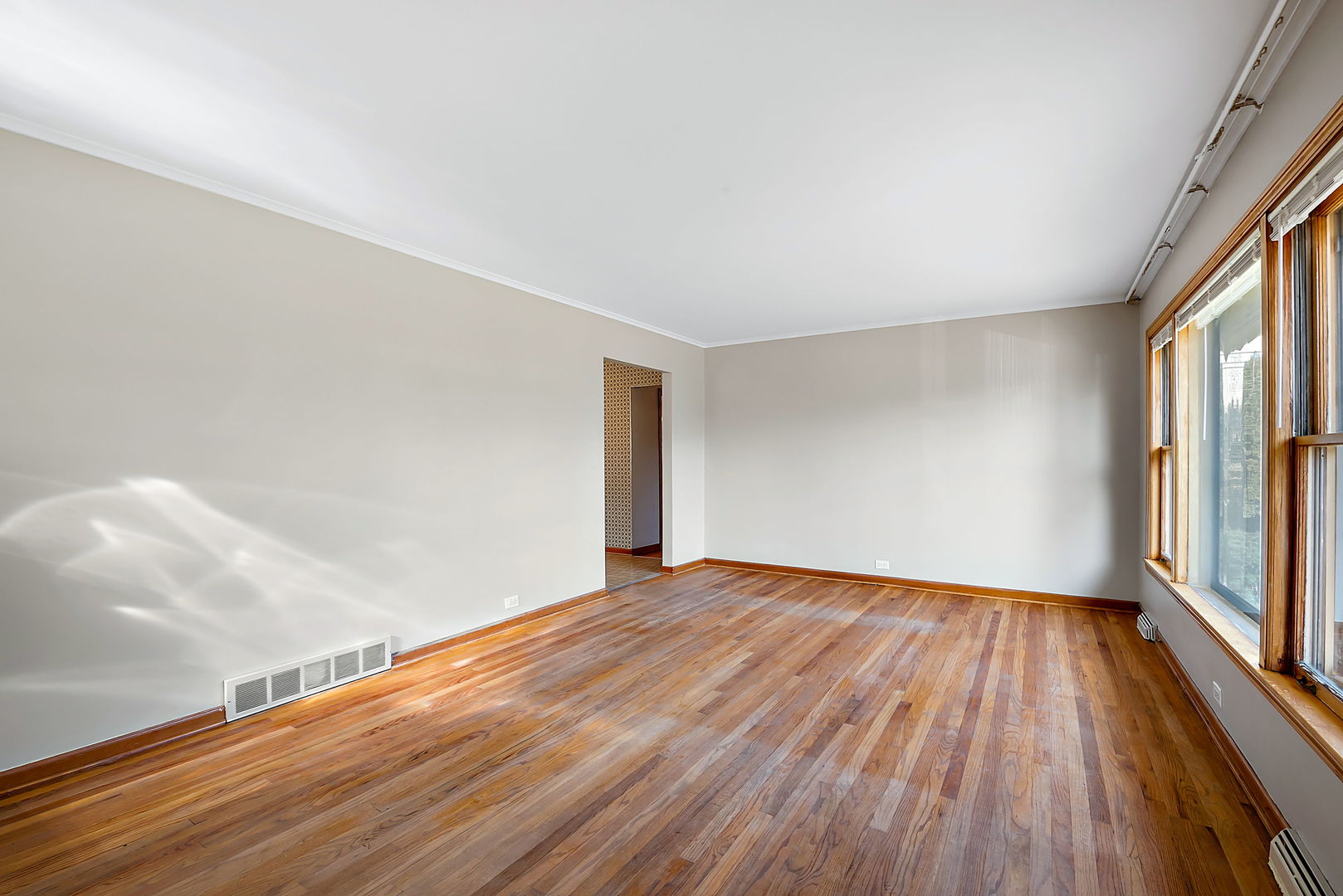 256 North Jackson Road Clarendon Hills, IL 60514 - Photo 5 of 30 a view of an empty room with wooden floor and a window