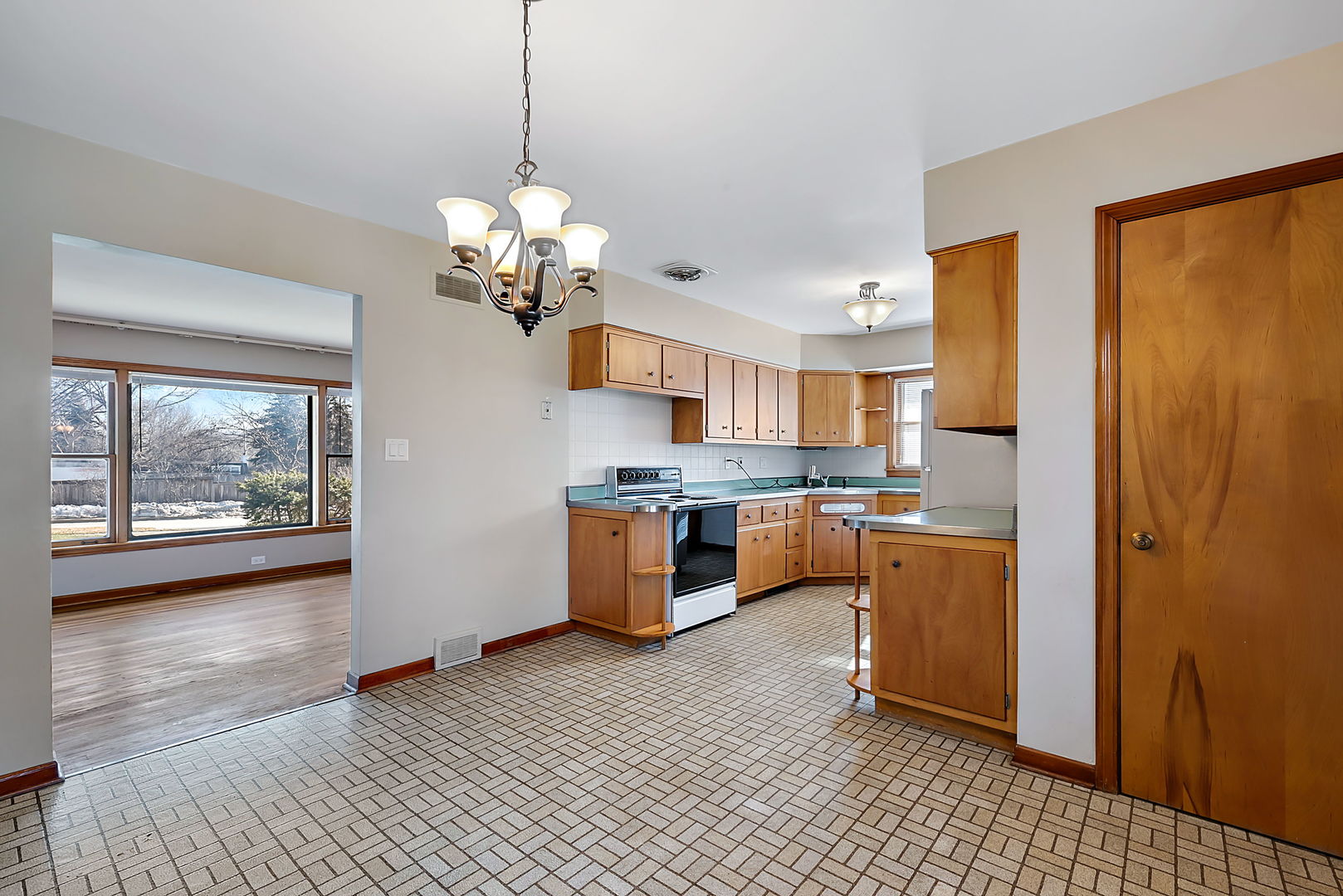 256 North Jackson Road Clarendon Hills, IL 60514 - Photo 6 of 30 a large kitchen with stainless steel appliances granite countertop a refrigerator a sink dishwasher a stove and white countertops with wooden floor