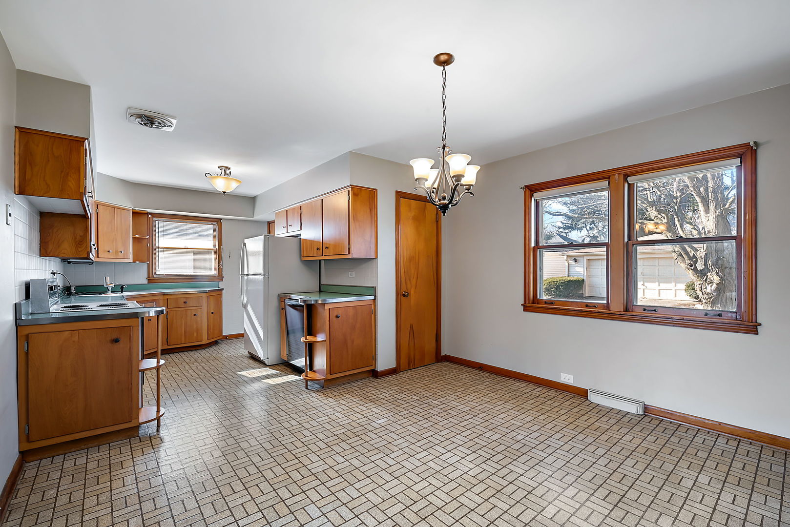 256 North Jackson Road Clarendon Hills, IL 60514 - Photo 7 of 30 a open kitchen with stainless steel appliances granite countertop a stove top oven a sink dishwasher and a refrigerator with wooden floor