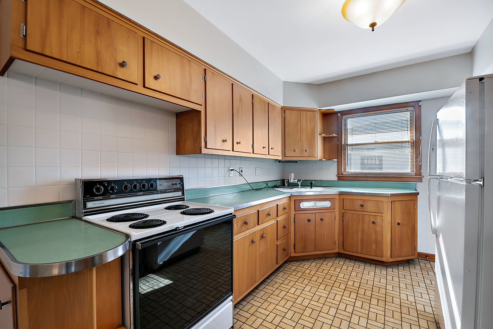 256 North Jackson Road Clarendon Hills, IL 60514 - Photo 8 of 30 a kitchen with a sink cabinets and a stove top oven