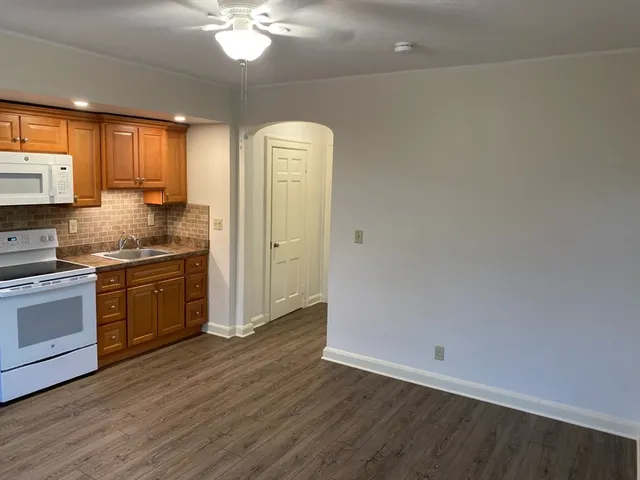 a kitchen with a refrigerator and a stove top oven