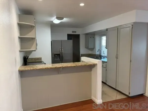 a kitchen with stainless steel appliances a refrigerator and a stove