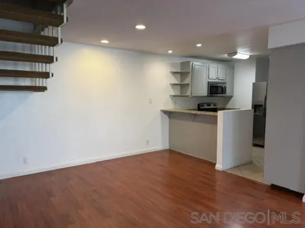 a kitchen with stainless steel appliances a refrigerator and a stove top oven