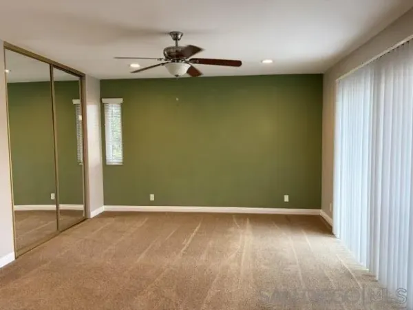 an empty room with a empty space and windows