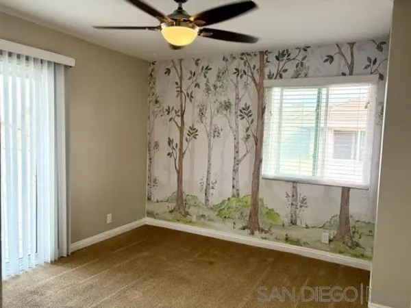 a bathroom with a granite countertop sink and a window