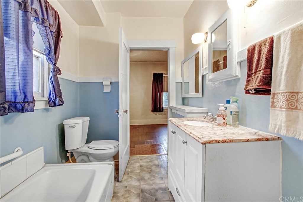 523 Lincoln Avenue Pasadena, CA 91103 - Photo 12 of 24 a bathroom with a granite countertop sink and a mirror