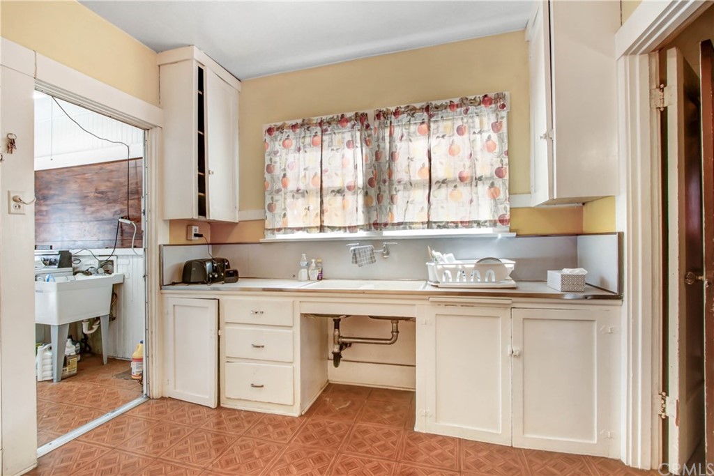 523 Lincoln Avenue Pasadena, CA 91103 - Photo 9 of 24 a kitchen with a stove a sink and cabinets