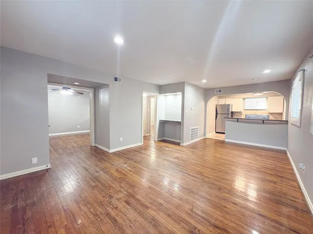 a view of an empty room and wooden floor
