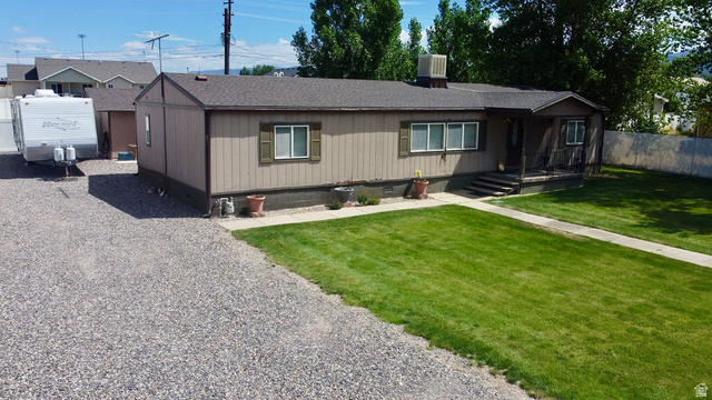 855 East 300 N Street Beaver, UT 84713 - Photo 44 of 44 Single-level residence featuring a gravel driveway, a grassy front yard, and a covered porch entry