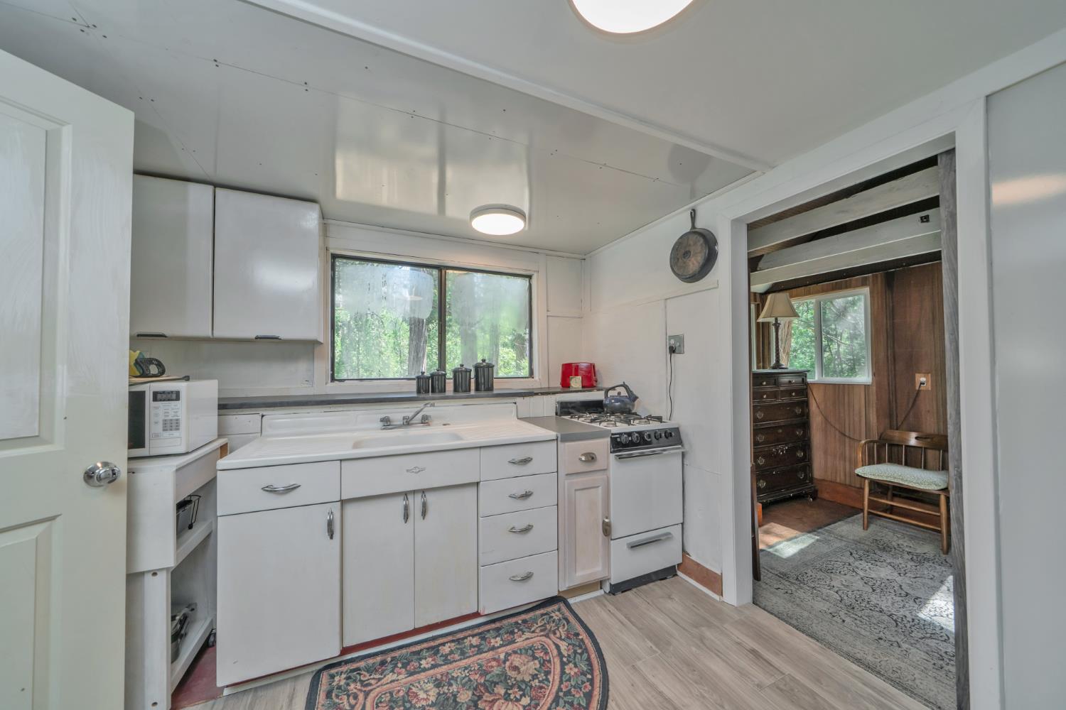 1334 School Road Kyburz, CA 95720 - Photo 12 of 36 a kitchen with a sink cabinets and wooden floor