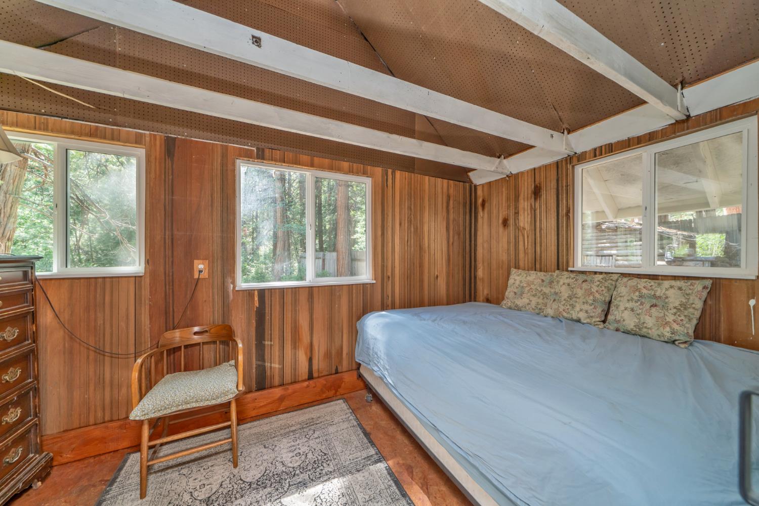 1334 School Road Kyburz, CA 95720 - Photo 18 of 36 a bedroom with a bed and wooden floor