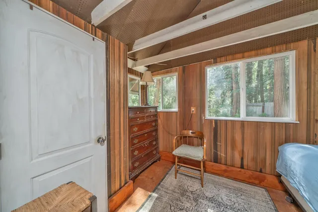 a view of a bedroom with furniture and a window