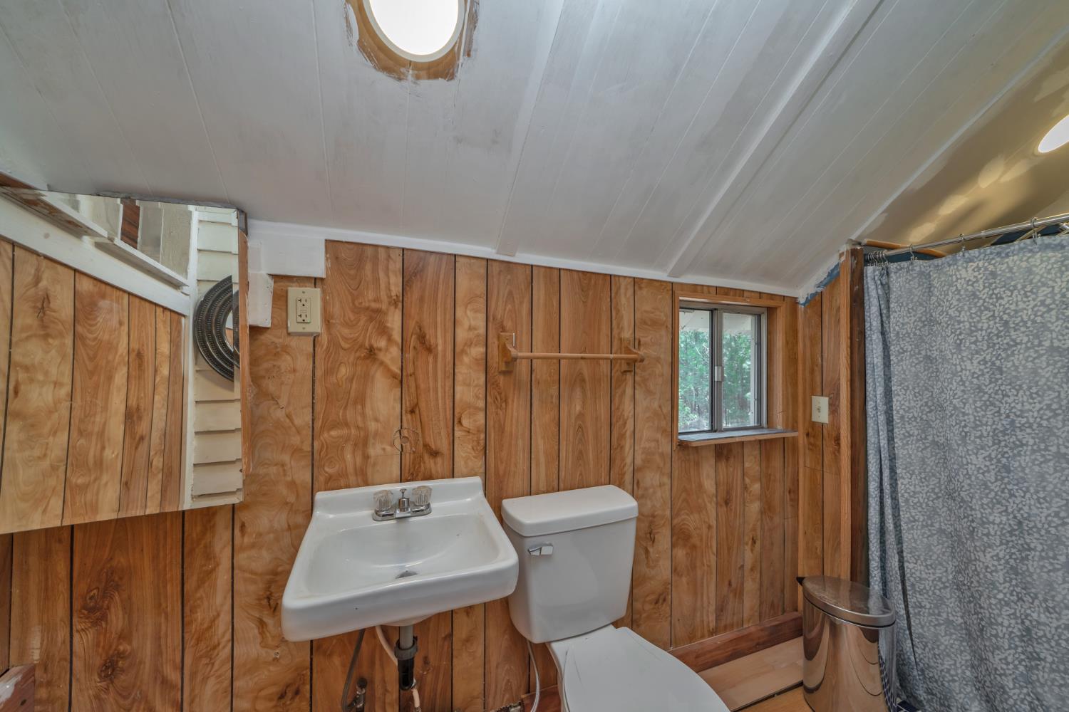 1334 School Road Kyburz, CA 95720 - Photo 22 of 36 a bathroom with a toilet a sink and a shower