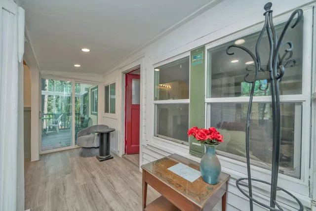 a living room with furniture and a floor to ceiling window