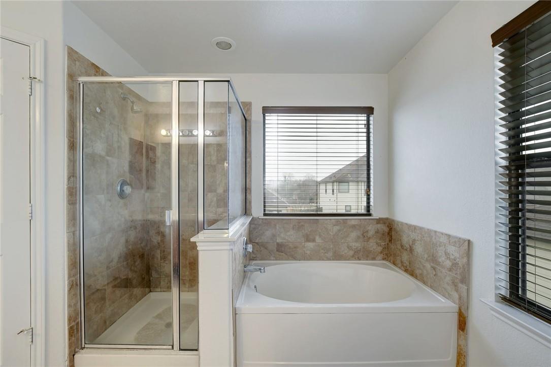356 Matthews Kyle, TX 78640 - Photo 13 of 30 Indulge in a tranquil bathing experience with this spacious soaking tub and adjacent walk-in shower.