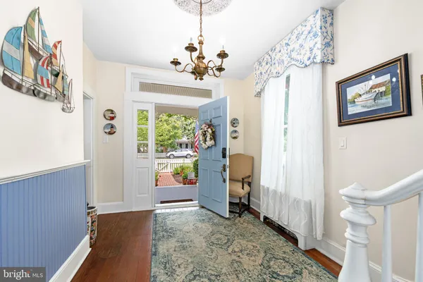a dining room with furniture a chandelier and a rug