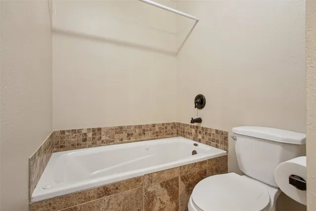 a bathroom with a granite countertop shower a mirror and a sink