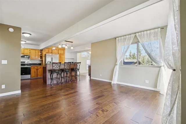 an empty room with wooden floor and furniture