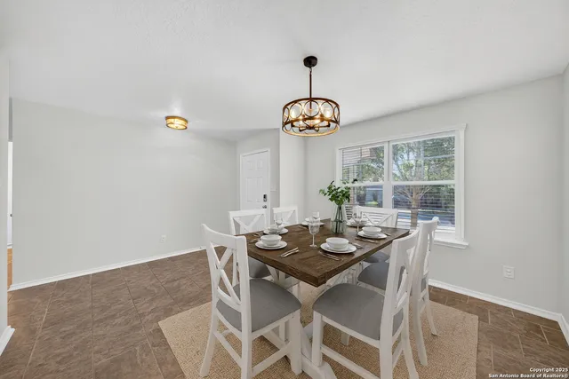a view of a dining room with furniture window and outside view