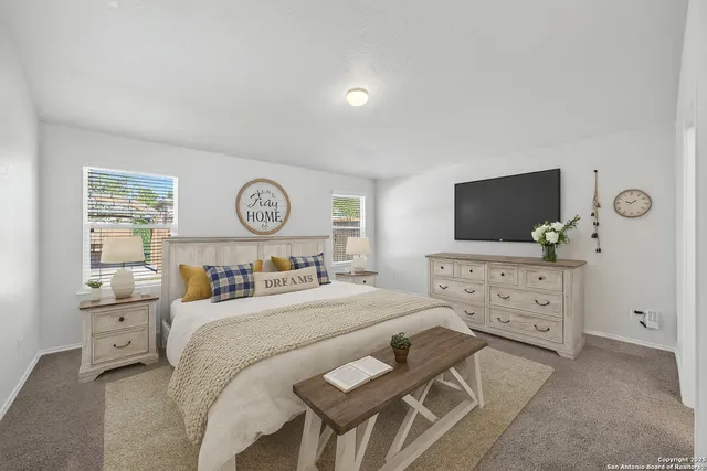 a bedroom with a bed and a flat screen tv in it