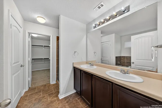 a bathroom with a sink double vanity and a mirror