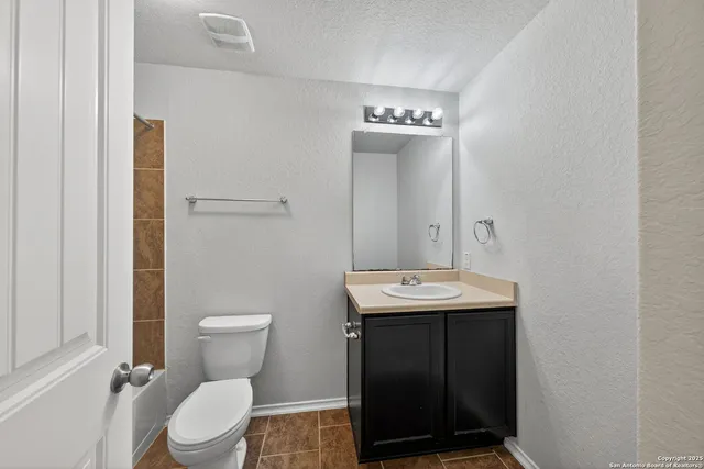 a bathroom with a sink a toilet and a mirror