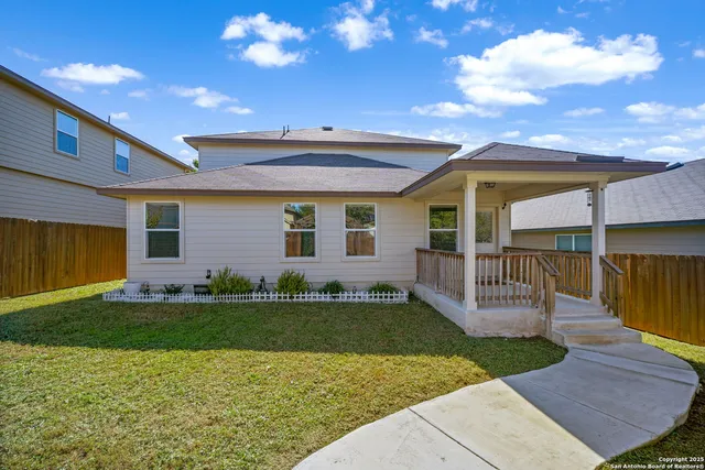 a view of a house with a backyard
