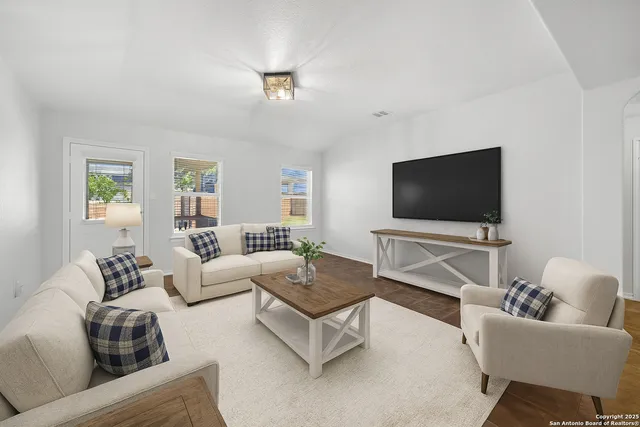 a living room with furniture and a flat screen tv