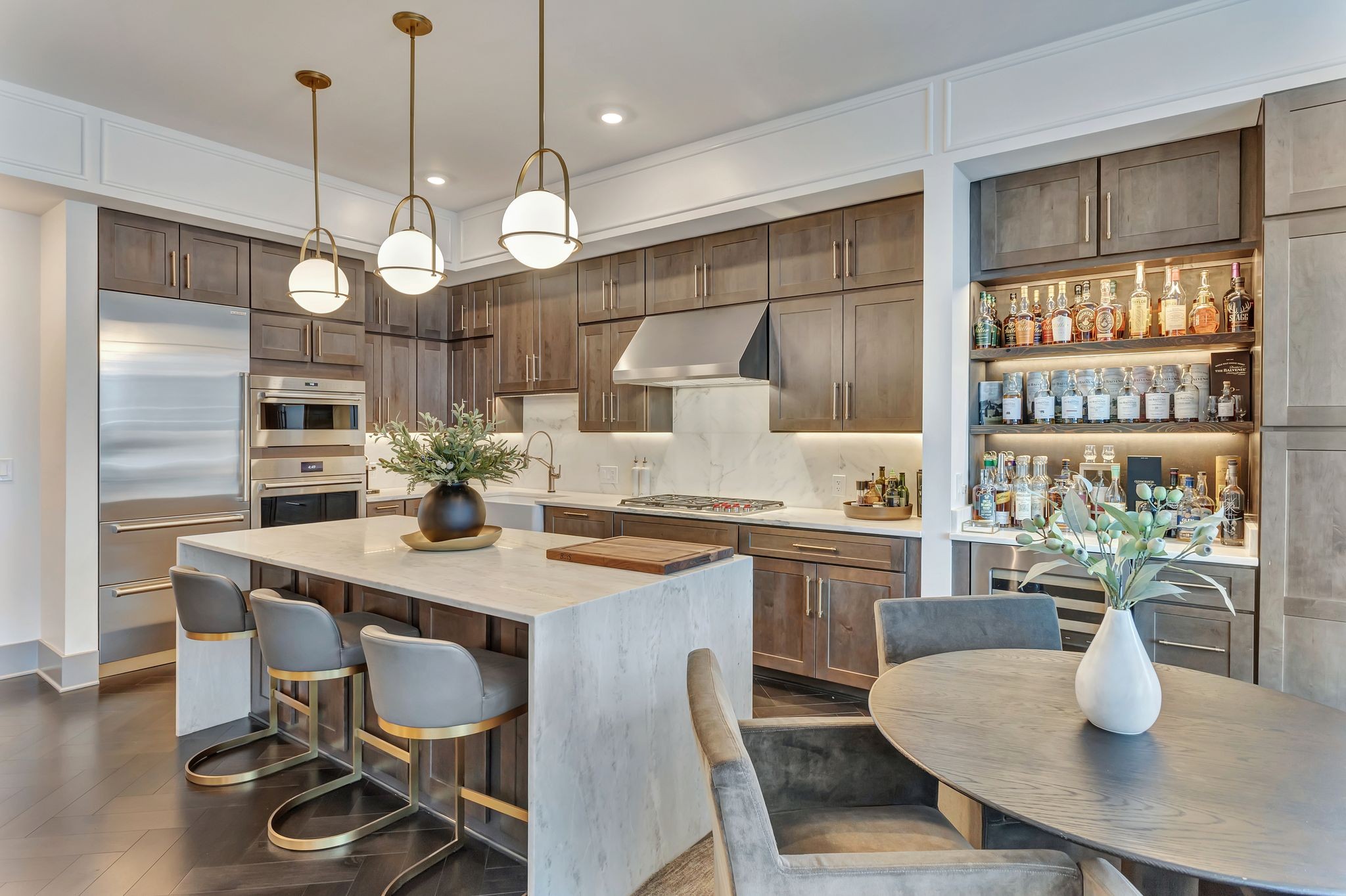 a kitchen with a dining table a stove a dining table and chairs with wooden floor