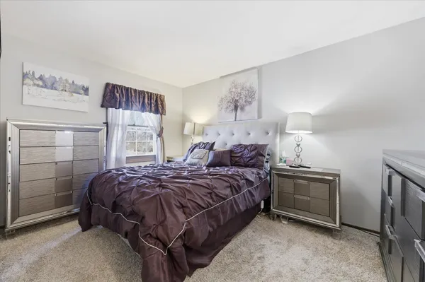 a bedroom with a bed and a night stand