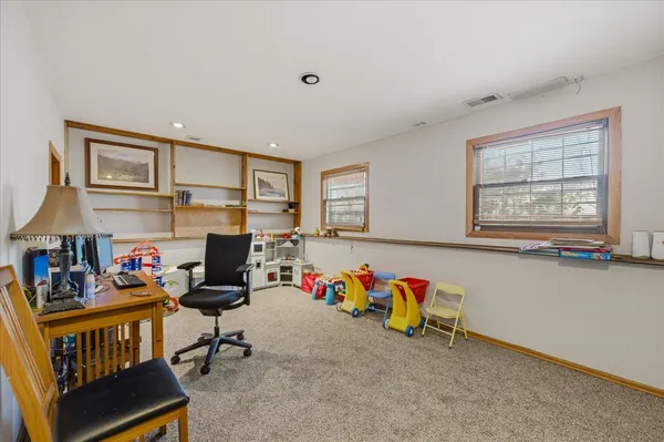 a living room with furniture fireplace and a window