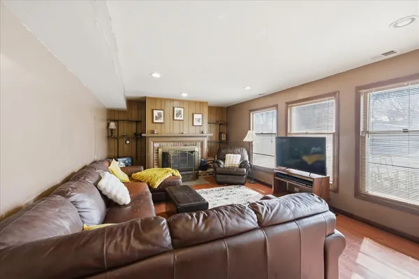 a living room with furniture a fireplace and a flat screen tv