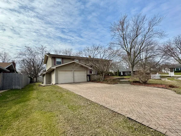 a view of a house with a yard covered with snow in front of house