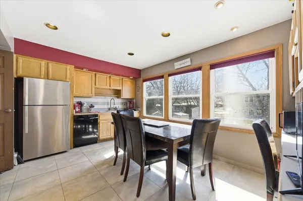 a dining room with furniture and a large window
