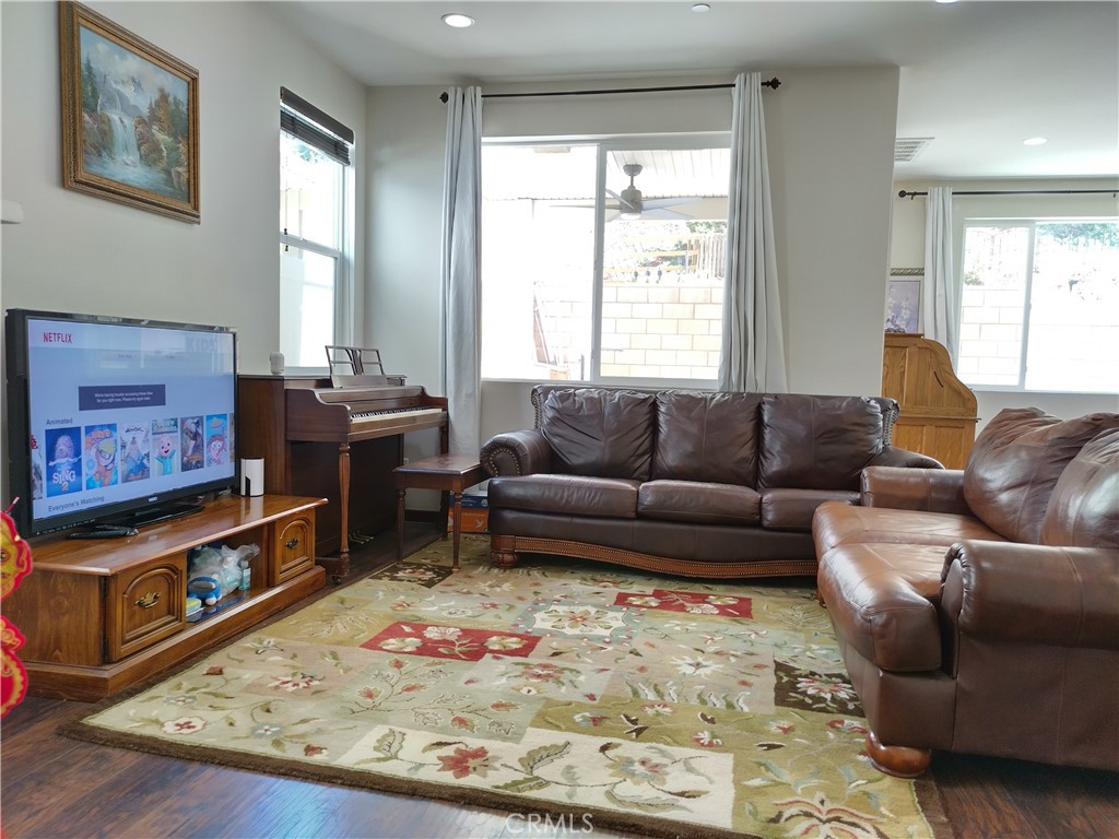 11811 Cramer Road Yucaipa, CA 92399 - Photo 11 of 56 a living room with furniture and a flat screen tv