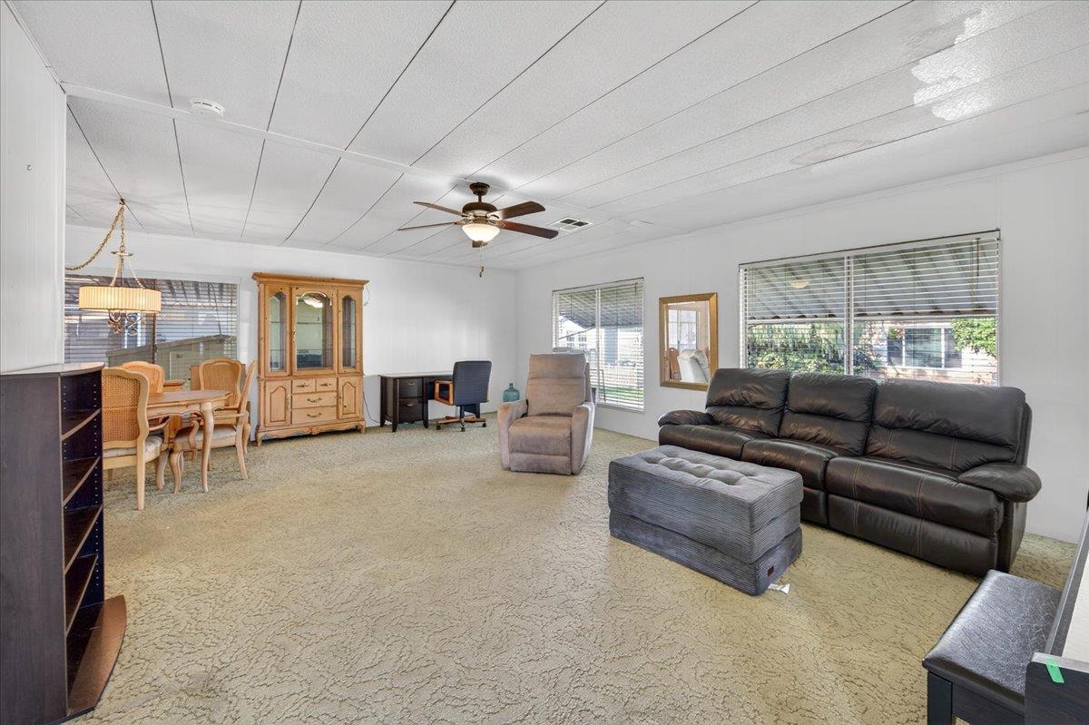 2706 West Ashlan Avenue, Unit 86 Fresno, CA 93705 - Photo 11 of 61 a living room with furniture and a chandelier