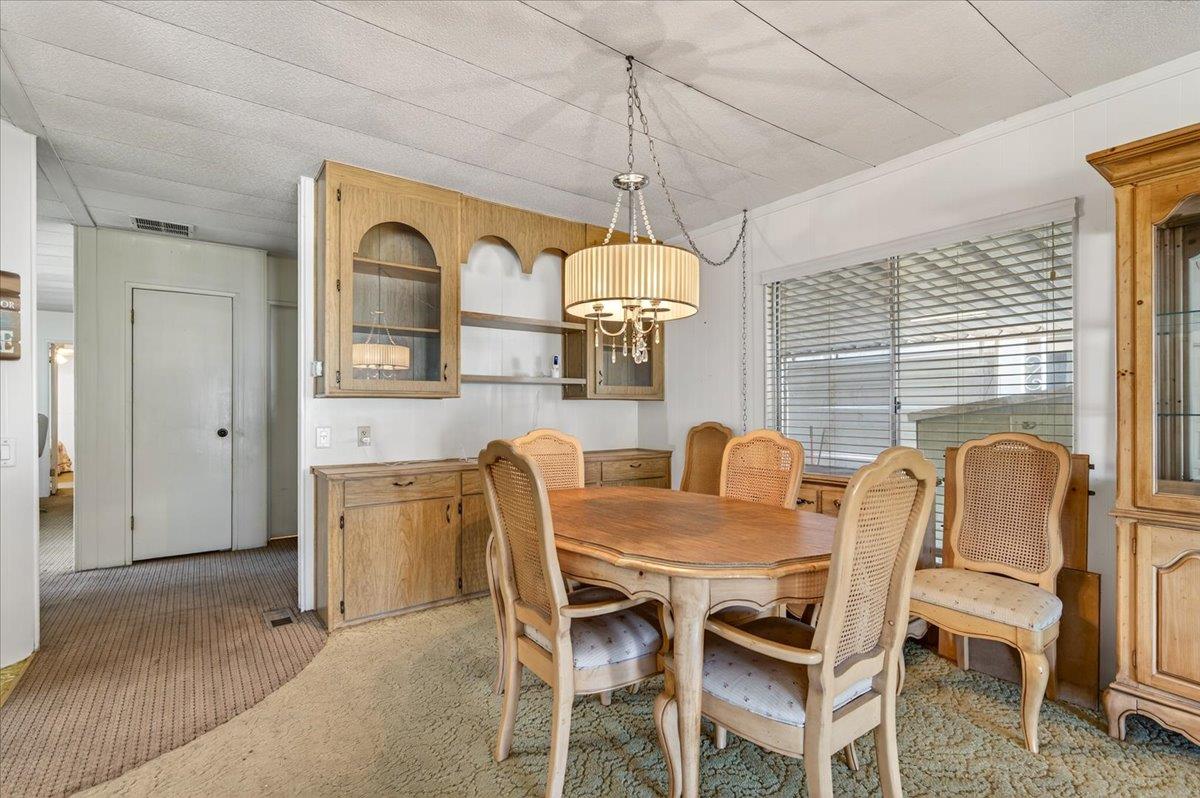 2706 West Ashlan Avenue, Unit 86 Fresno, CA 93705 - Photo 13 of 61 a dining room with furniture and window