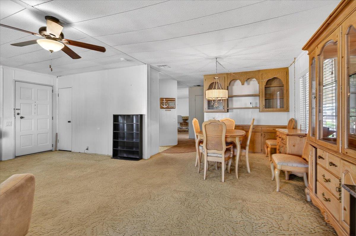 2706 West Ashlan Avenue, Unit 86 Fresno, CA 93705 - Photo 14 of 61 a view of a livingroom with furniture and a ceiling fan