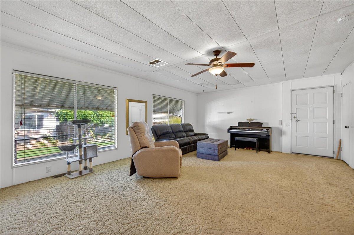 2706 West Ashlan Avenue, Unit 86 Fresno, CA 93705 - Photo 16 of 61 a living room with furniture and a large window