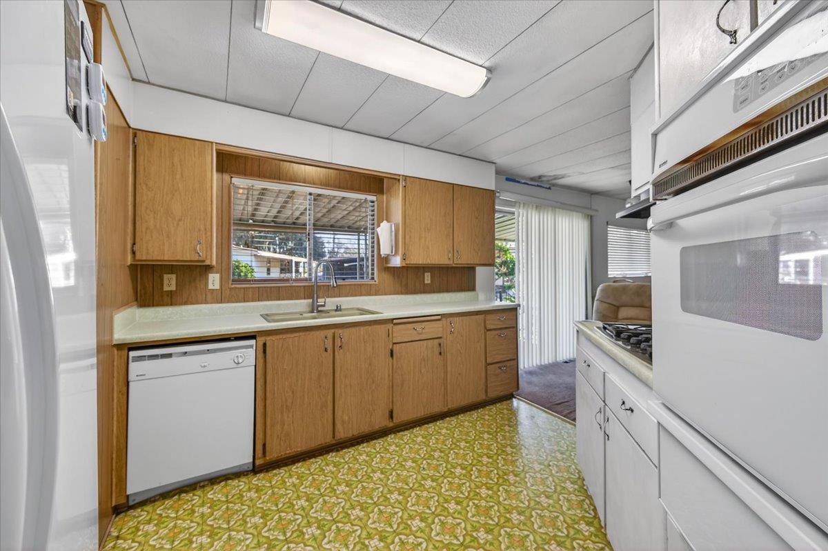 2706 West Ashlan Avenue, Unit 86 Fresno, CA 93705 - Photo 17 of 61 a large kitchen with a window and stainless steel appliances