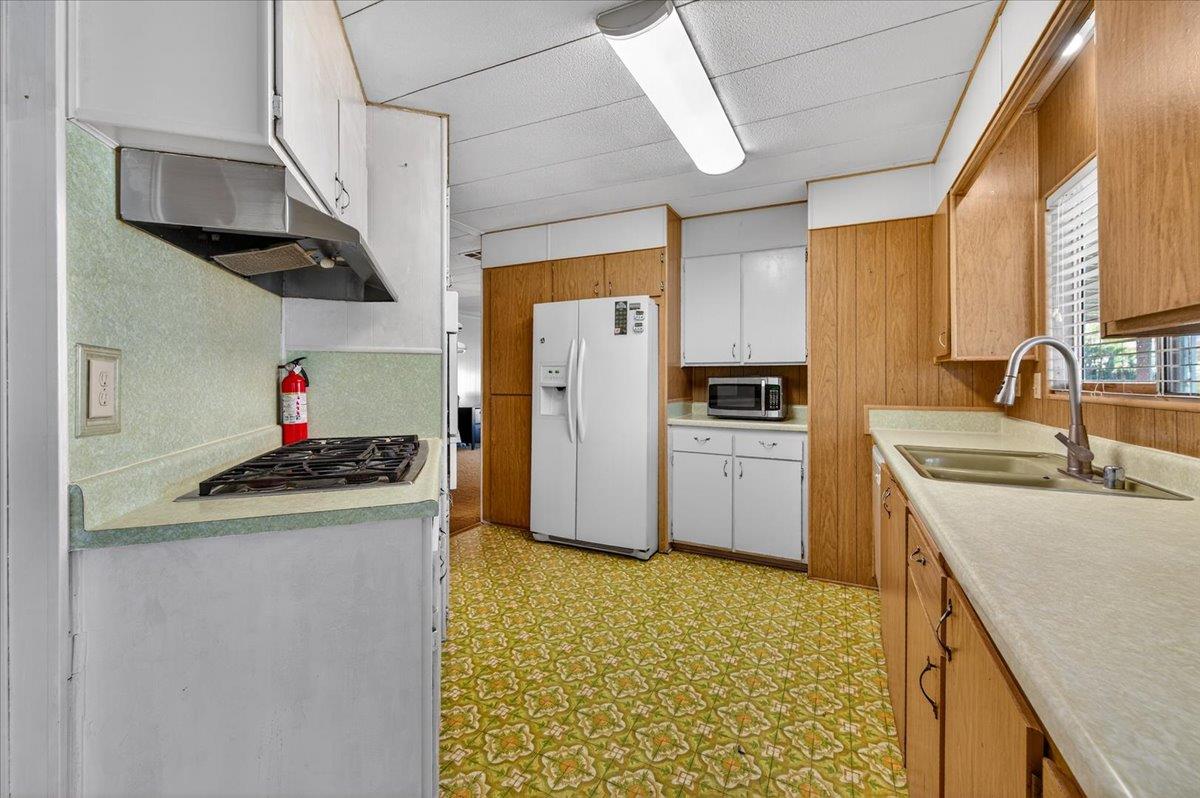 2706 West Ashlan Avenue, Unit 86 Fresno, CA 93705 - Photo 19 of 61 a kitchen with stainless steel appliances granite countertop a sink and a refrigerator