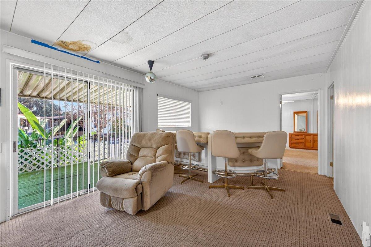 2706 West Ashlan Avenue, Unit 86 Fresno, CA 93705 - Photo 21 of 61 a living room with furniture and a floor to ceiling window