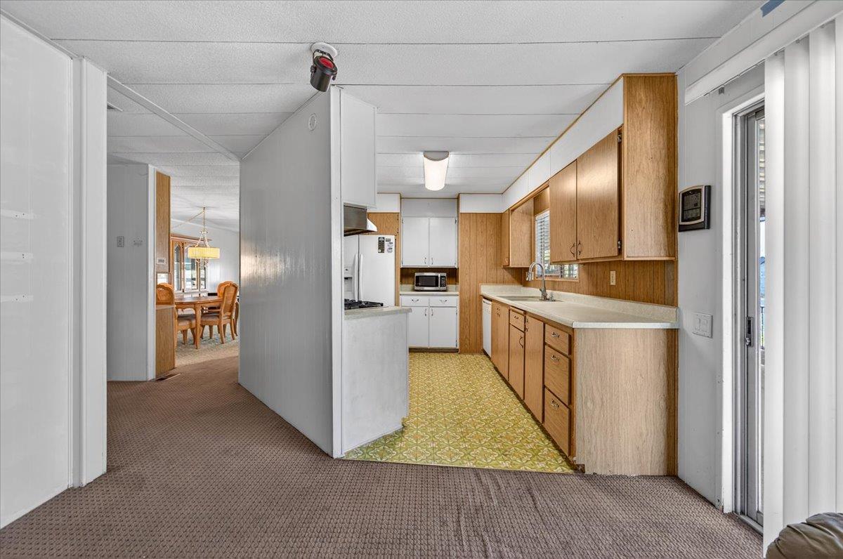 2706 West Ashlan Avenue, Unit 86 Fresno, CA 93705 - Photo 23 of 61 a kitchen with refrigerator and cabinets