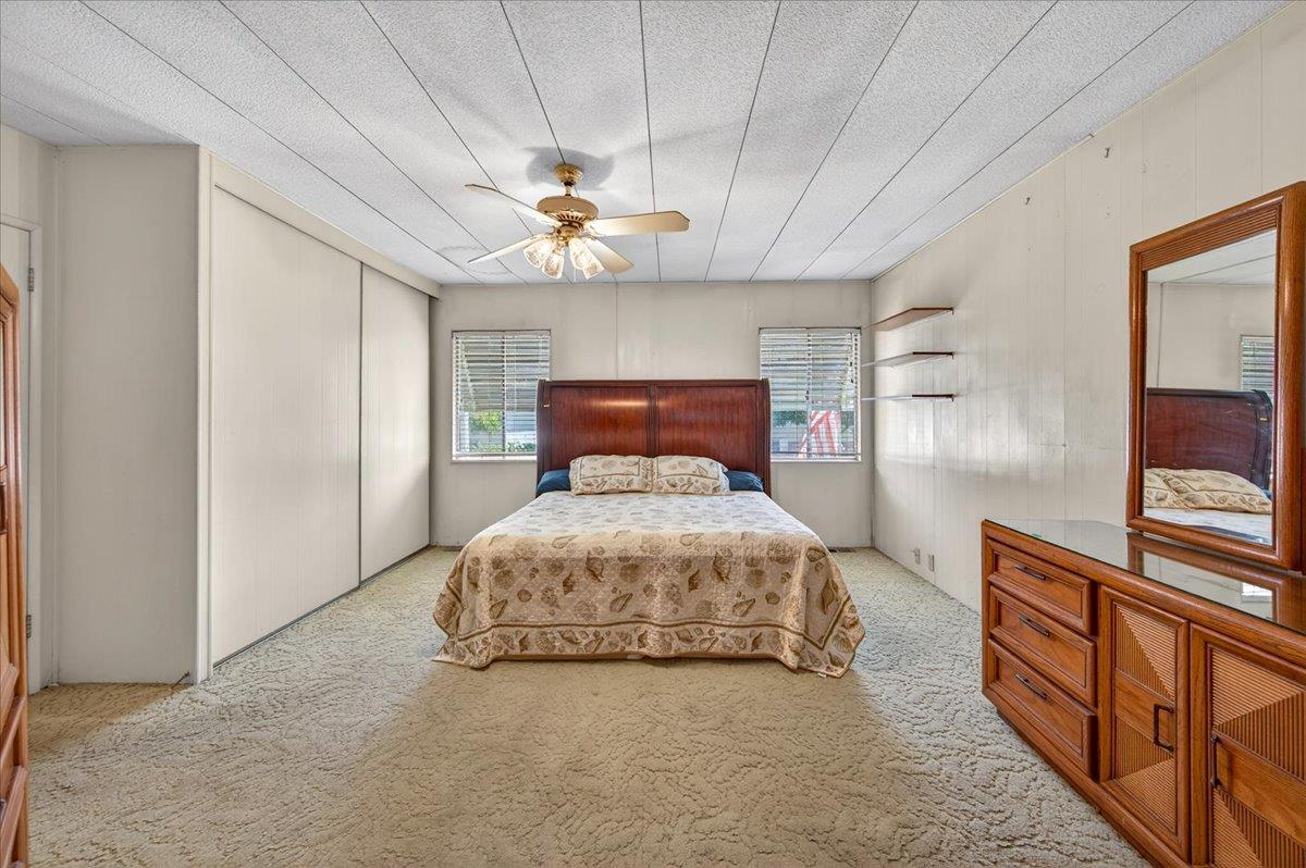 2706 West Ashlan Avenue, Unit 86 Fresno, CA 93705 - Photo 30 of 61 a bedroom with a bed and wooden floor