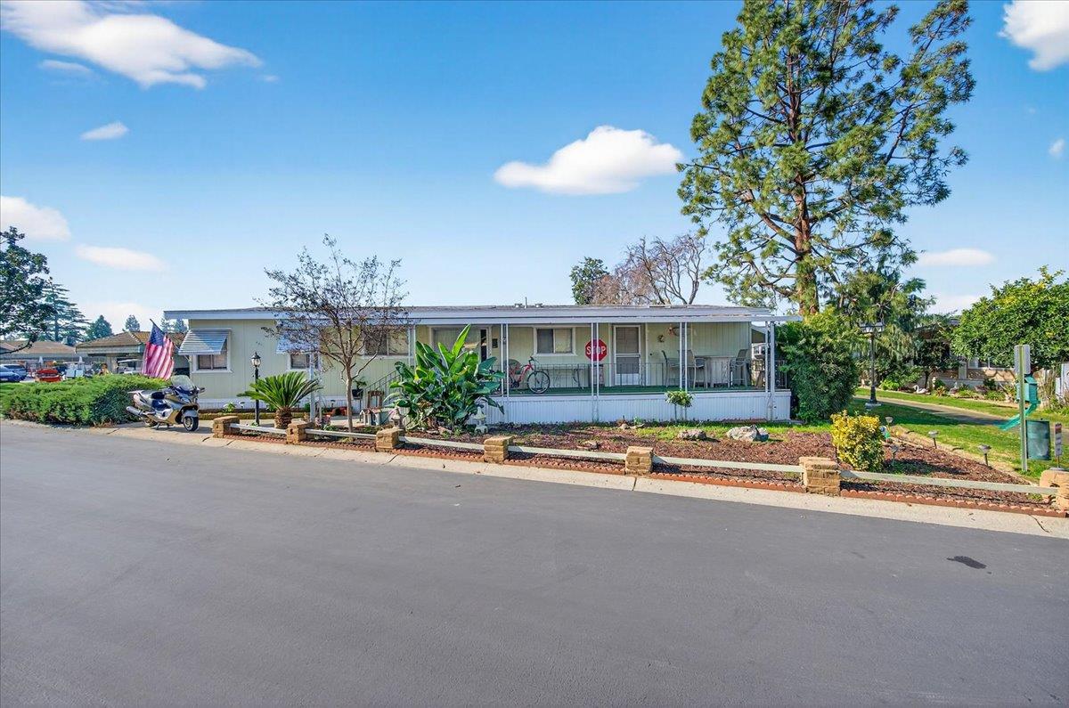2706 West Ashlan Avenue, Unit 86 Fresno, CA 93705 - Photo 3 of 61 a front view of a house with a garden and patio