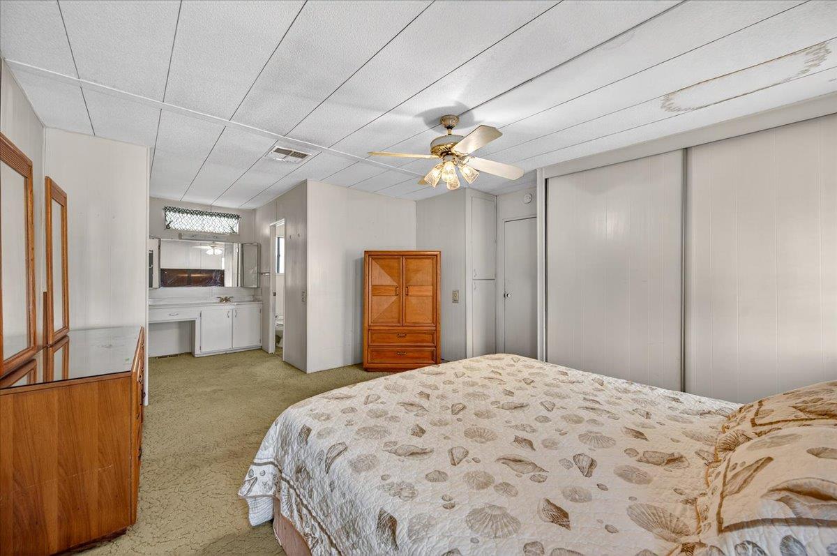 2706 West Ashlan Avenue, Unit 86 Fresno, CA 93705 - Photo 32 of 61 a bedroom with a bed and a chandelier