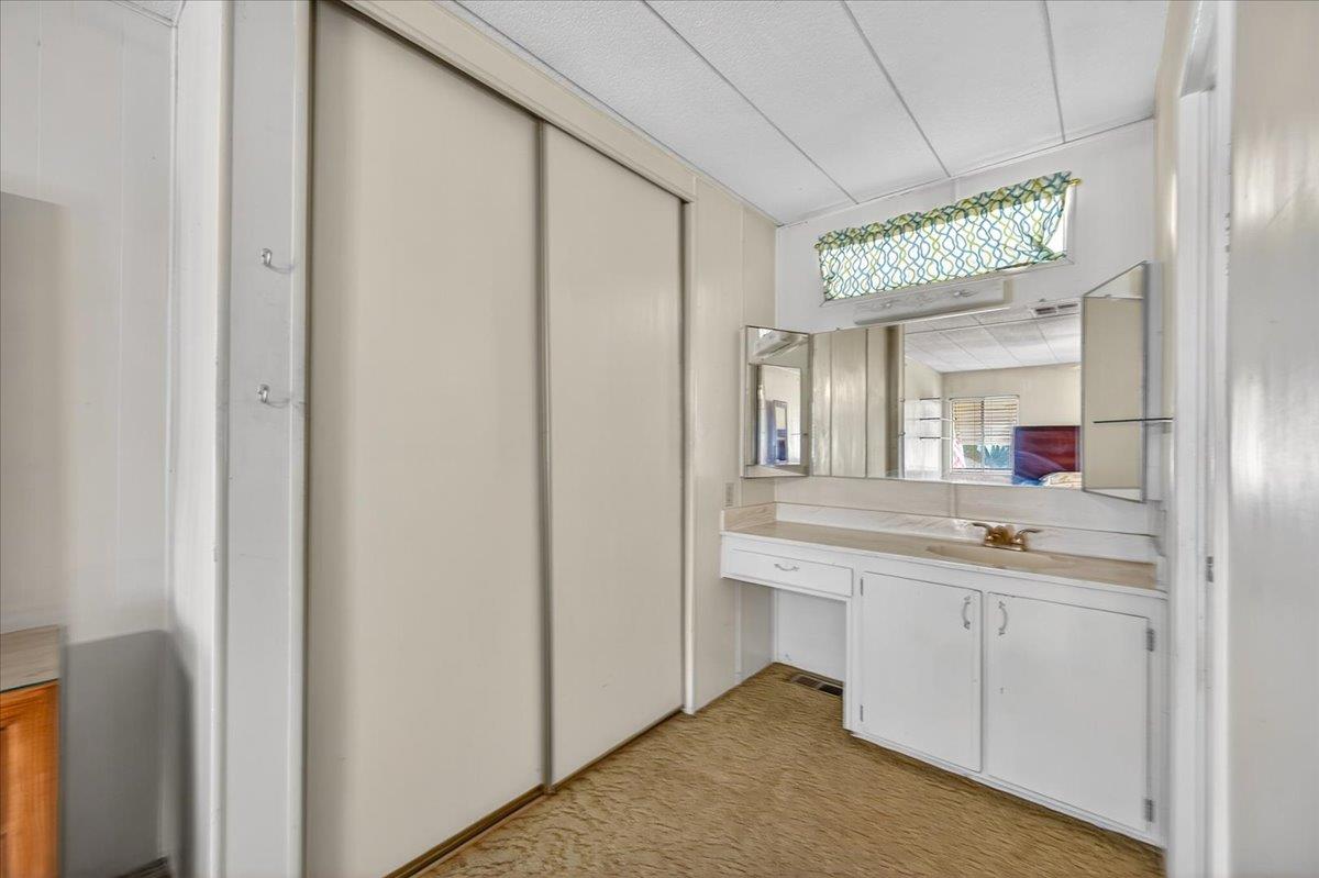 2706 West Ashlan Avenue, Unit 86 Fresno, CA 93705 - Photo 34 of 61 a bathroom with a sink and a mirror